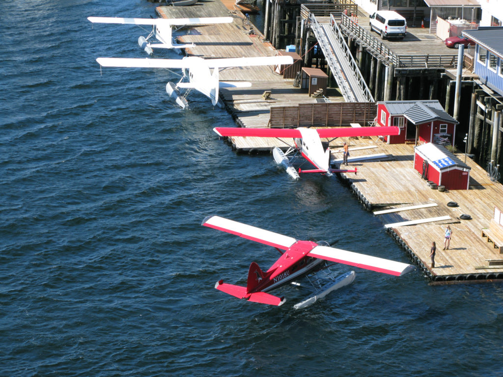 A sea plane pulling up to a dock in Ketchikan